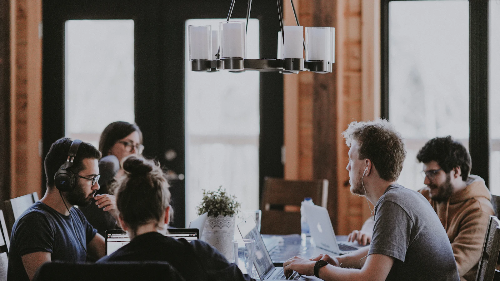 Modern open office where professionals collaborate at desks with laptops